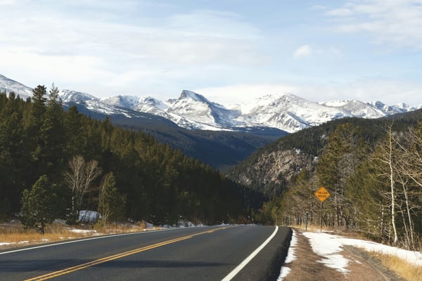 Colorado mountain highway with snow-capped peaks