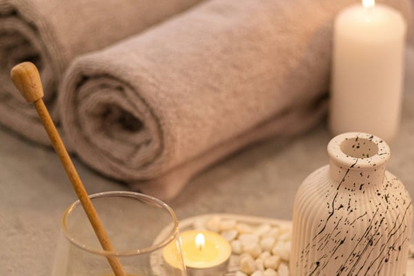 Spa massage table with candles and towels