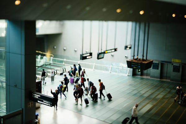 Travelers moving through a modern airport terminal